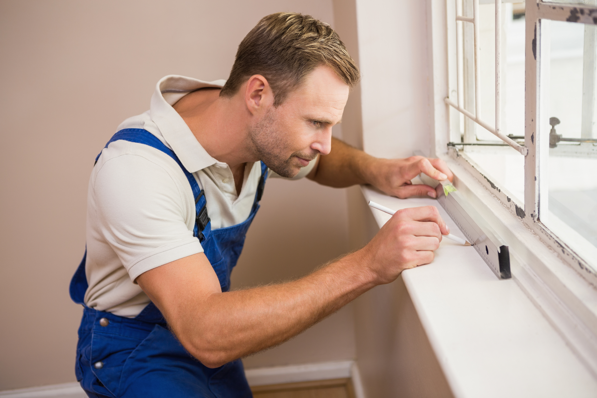 Construction worker using spirit level in a new house